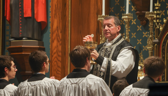 Fr. gives communion to the servers