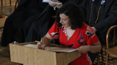 Student signs campus registry