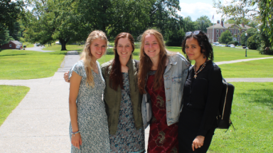 Three summer programmers pose with a prefect