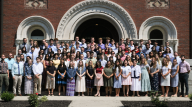 The New England programmers pose for a photo afront one of the buildings