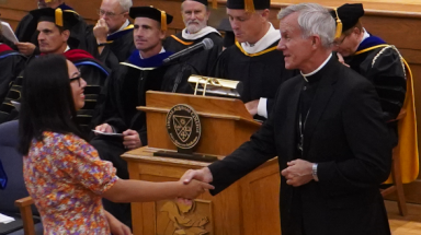 Student greets Bishop Stricklant at Matriculation ceremony