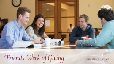 Students laugh and discuss the text, with the FWG 2022 banner visible underneath