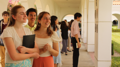 Students admire artworks posted on the pillars of the arcade