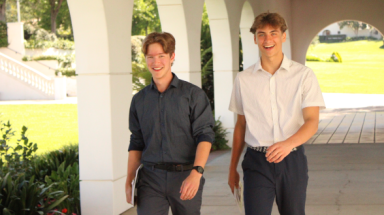 Two students walking through arcade