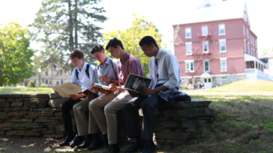 Students study on the rock wall by Merrill-Keep