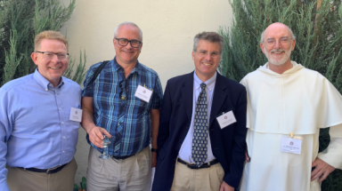 Four conference attendees pose for a picture