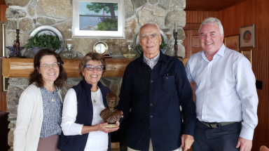 Thomas Aquinas College president Dr. Paul J. O’Reilly (right) and his wife, Peggy (left), present a bust of St. Albert the Great to June and Jack Heffernan.