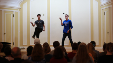 Two juggle onstage at Open Mic Night