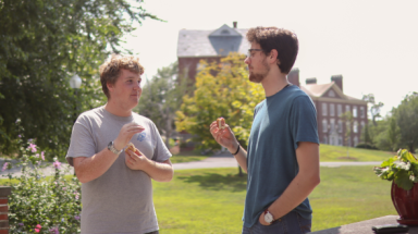 Two chatting over hot dogs