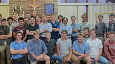 The 22 members of the project pose together for a photo