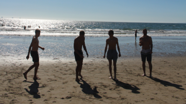 Four silhouetted against the water