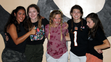 Five pose for a photo