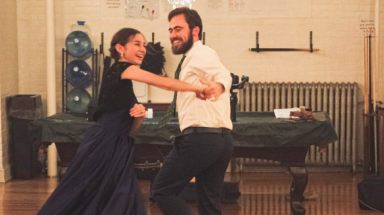Two dance, laughing