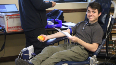 A student gives blood
