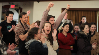 Students cheer as the last thesis is turned in