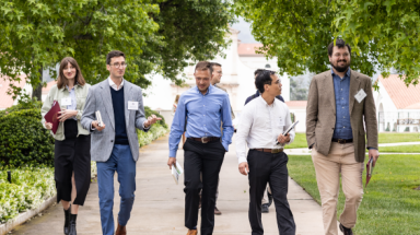 Seven walk and chat together along the path