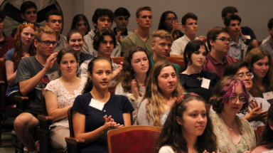 Students seated in the Auditorium applaud