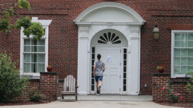 A student runs into his dorm