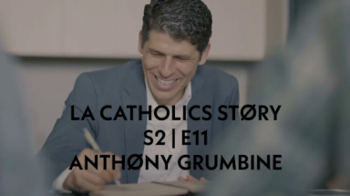A smiling man writing in a book with the words "LA Catholics Story S2 | E11 Anthony Grumbine" overtop.