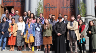 New England students and faculty pose for a photo in Boston