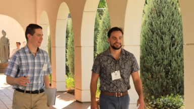 Two students walk along the academic quadrangle
