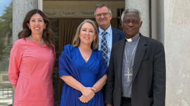 Caption: Dr. Pia de Solenni (’93), senior director of corporate engagement for IWP Capital, with IWP CEO Sam Saladino, his wife, Cara, and His Eminence Peter Cardinal Turkson, Chancellor of the Pontifical Academy of Sciences