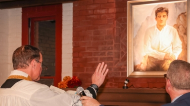 Fr, Markey blesses photo of Bl. Pier Giorgio Frassati