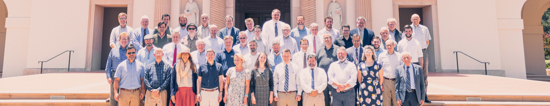 Faculty from both campuses pose together for a photo on the steps of the California chapel