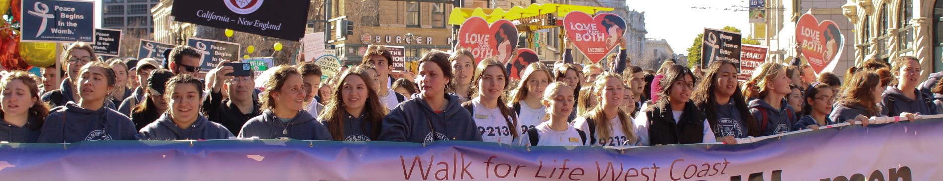Students push forward, holding the Walk for Life banner