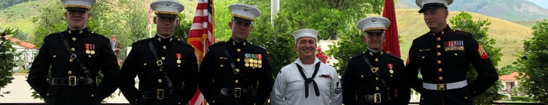Alumnus Presents Two Graduates with Marine Corps Commissions