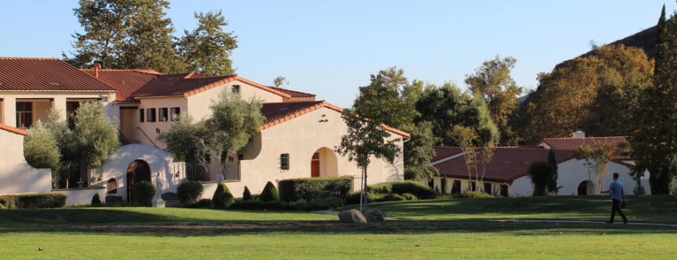 Student walking toward residence hall.