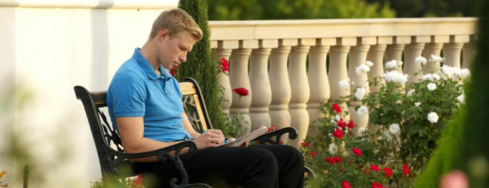 Student reads on a bench