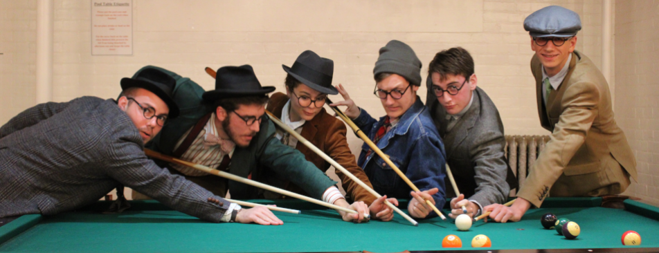 Students pose at the pool table during the Halloween Dance