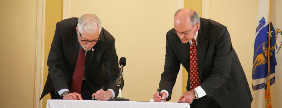 Signing at transfer of New England campus in 2017