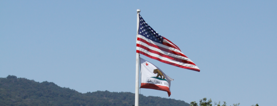 US and California flags fly over the California campus