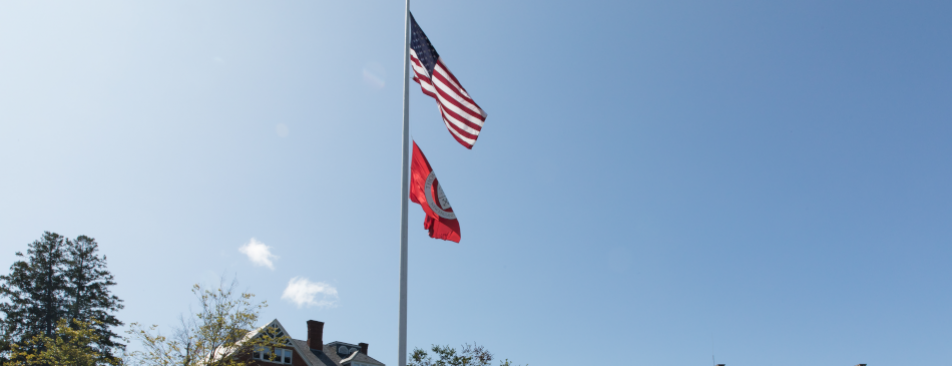 US and TAC flags fly over the New England campus