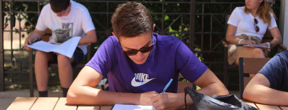 A student takes notes during the New England Summer Program