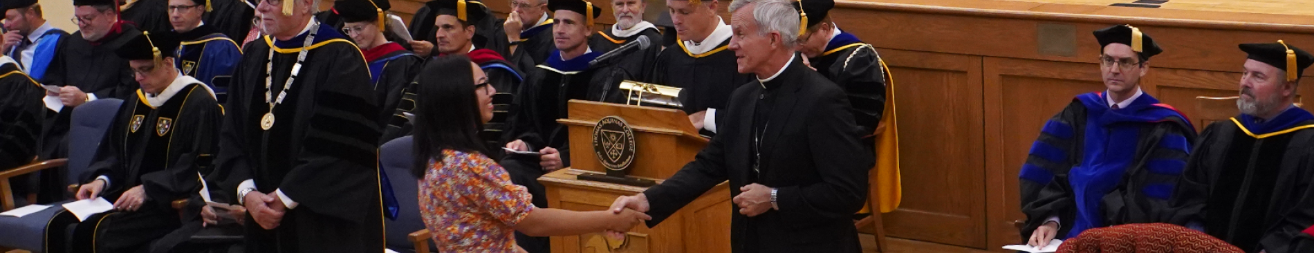 Student greets Bishop Stricklant at Matriculation ceremony
