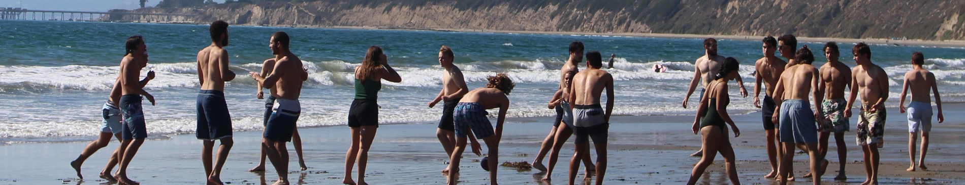 Students play at the water's edge