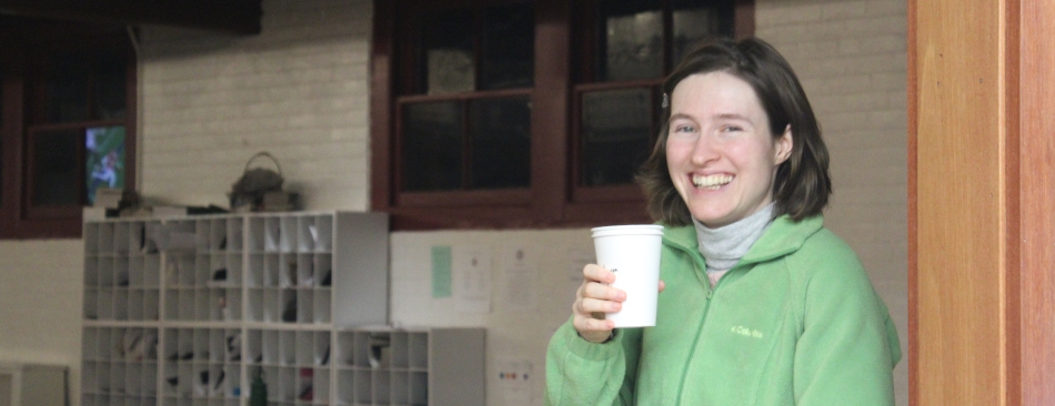 A student drinks a cup of coffee