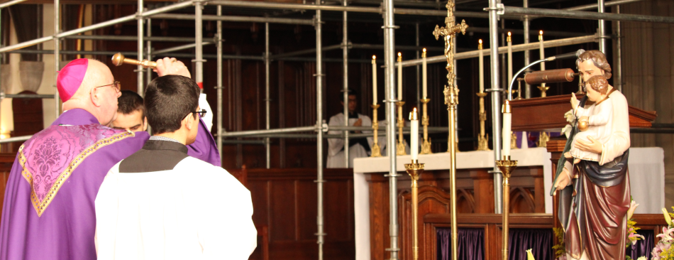Bishop Byrne blesses a statue of St. Joseph