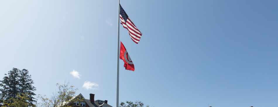 US and TAC flags fly over the New England campus