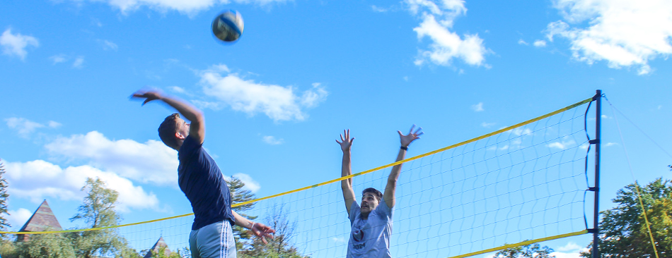 Student spikes volleyball
