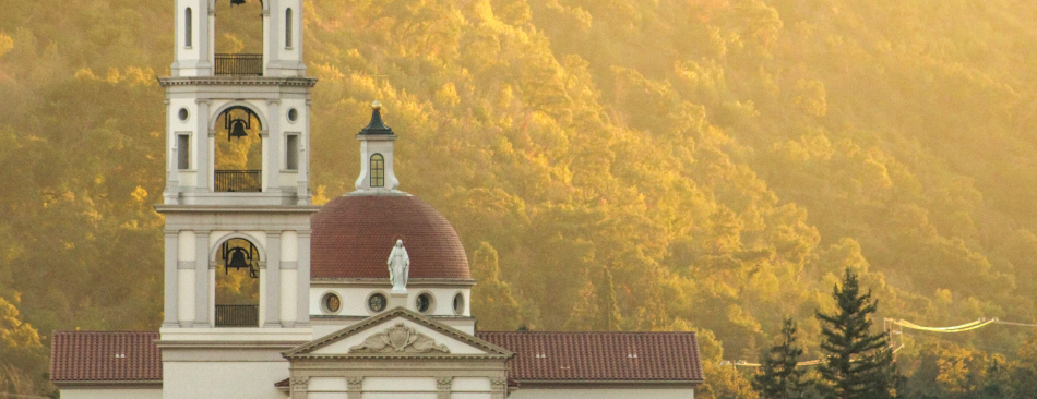 Sun sets on the mountains behind the California chapel