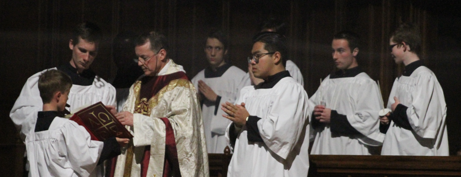 Fr. Markey reads the reading in semidarkness